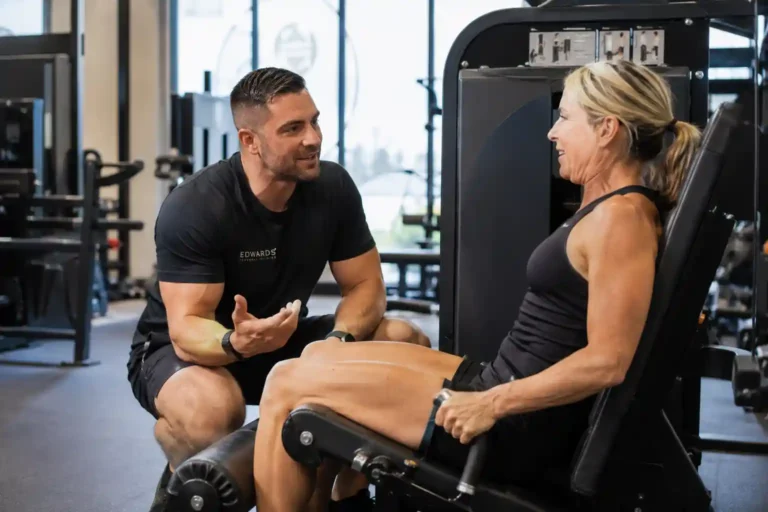 A certified personal trainer in Winter Park coaching a client through strength training exercises in a modern fitness studio