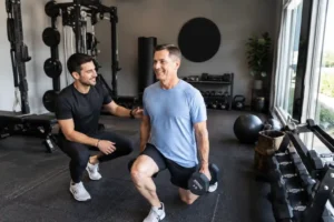Professional man and woman working with a personal trainer in a private fitness studio in Winter Park, Florida